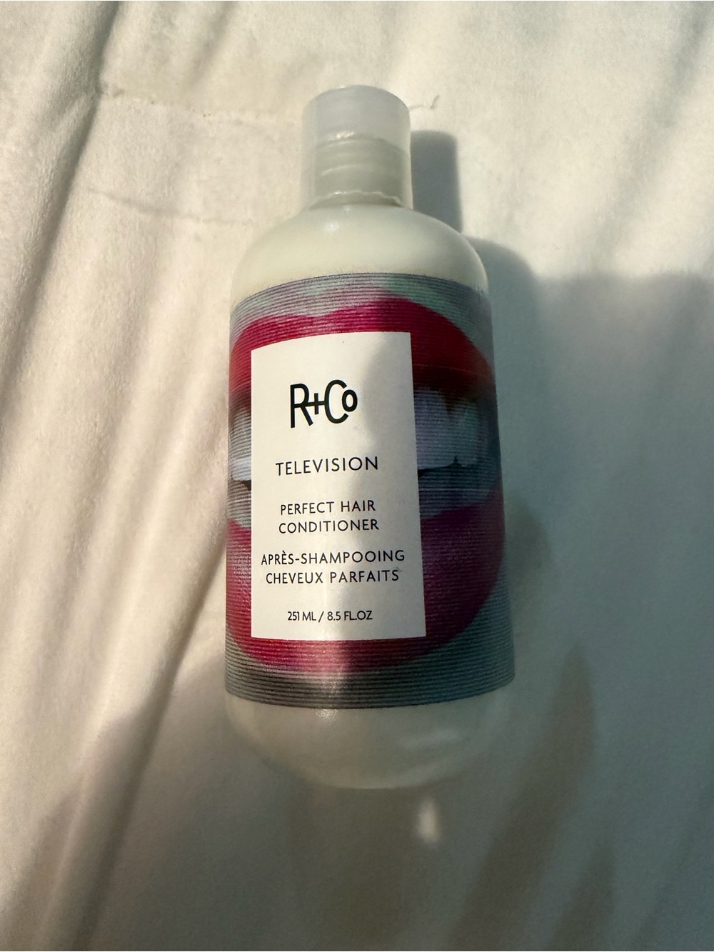 R+Co Conditioner Bottle with Pink and White Label